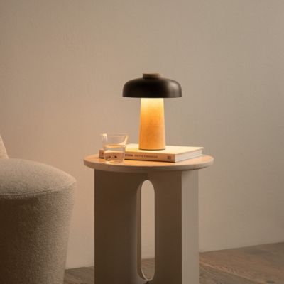 Shown in Sand Travertine Base with Bronzed Brass Shade finish, in use