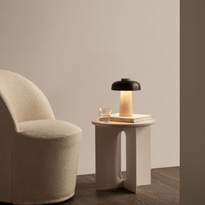 Shown in Sand Travertine Base with Bronzed Brass Shade finish, in use