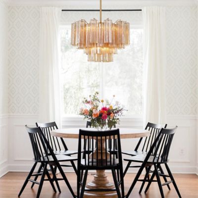 Shown in Aged Brass finish, Amber shade color, 9 lights, in use, lit