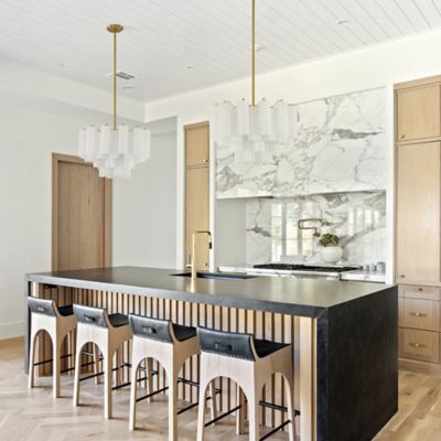 Shown in Aged Brass finish, White shade color, 9 lights, in use, lit