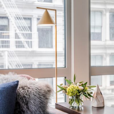 Shown in Brass with White Carrara Marble Base finish, in use, lit