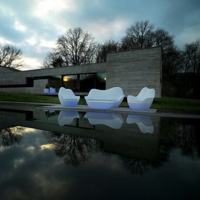 White floating outdoor lounge seating with water reflections.